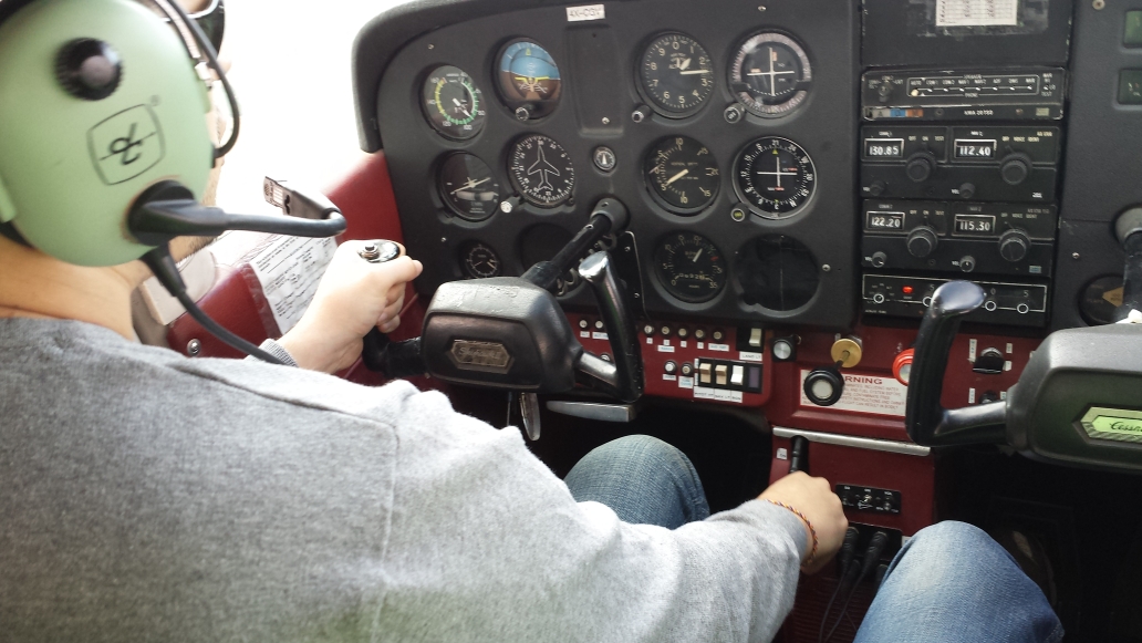 A pilot is flying the Cessna 172 airplane and trims it for straight and level flight in Israel